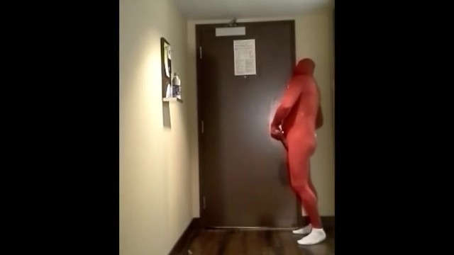 Red Morphsuit Jerking off at Hotel Room Door