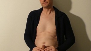 Kudoslong posing on a table in a jacket his flaccid penis is shaved smooth. He starts masturbating and is soon erect