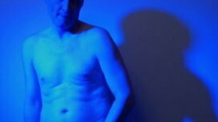 Kudoslong nude in a blue light playing with his flaccid cock