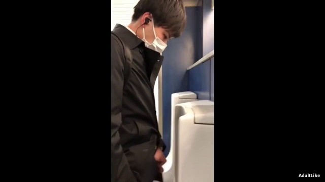 A male is pissing in the toilet 11.